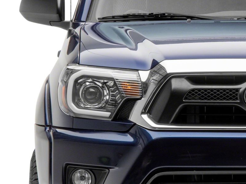 Raxiom 12-15 Toyota Tacoma Axial Projector Headlights w/ SEQL LED Bar- Black Housing (Clear Lens)