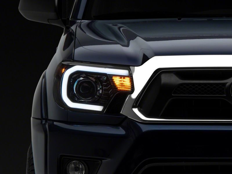 Raxiom 12-15 Toyota Tacoma Axial Series Projector Headlights w/ LED Bar- Black Housing (Clear Lens)