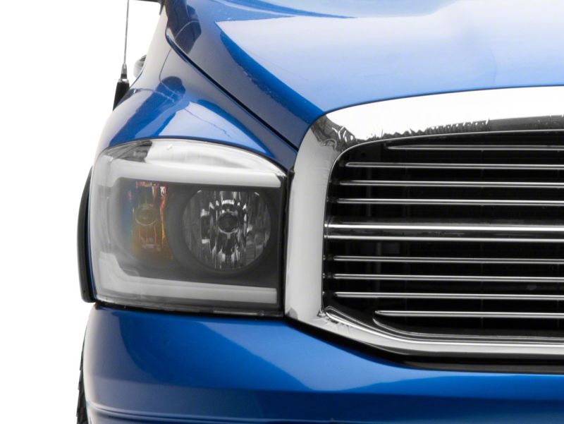 Raxiom 06-09 Dodge RAM 1500/2500/3500 Axial Headlights w/ SEQL LED Bar- Black Housing (Clear Lens)