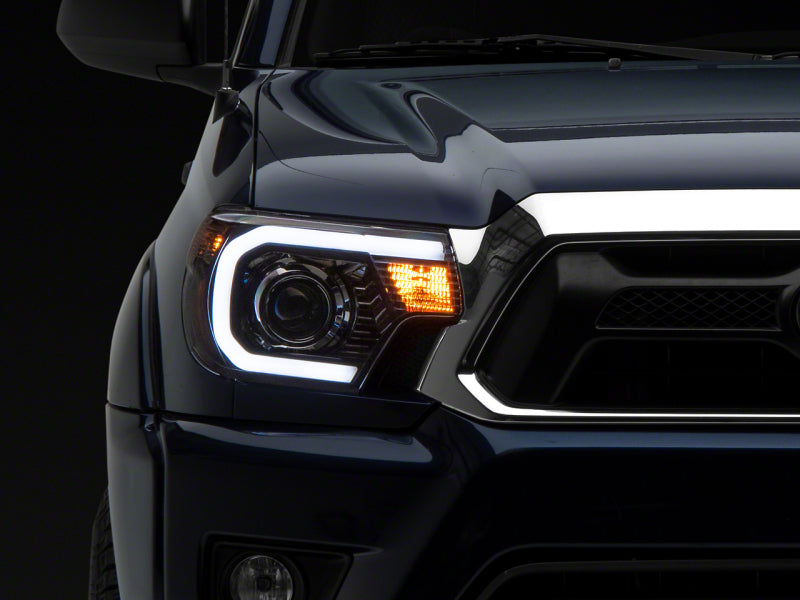 Raxiom 12-15 Toyota Tacoma Axial Projector Headlights w/ SEQL LED Bar- Black Housing (Clear Lens)