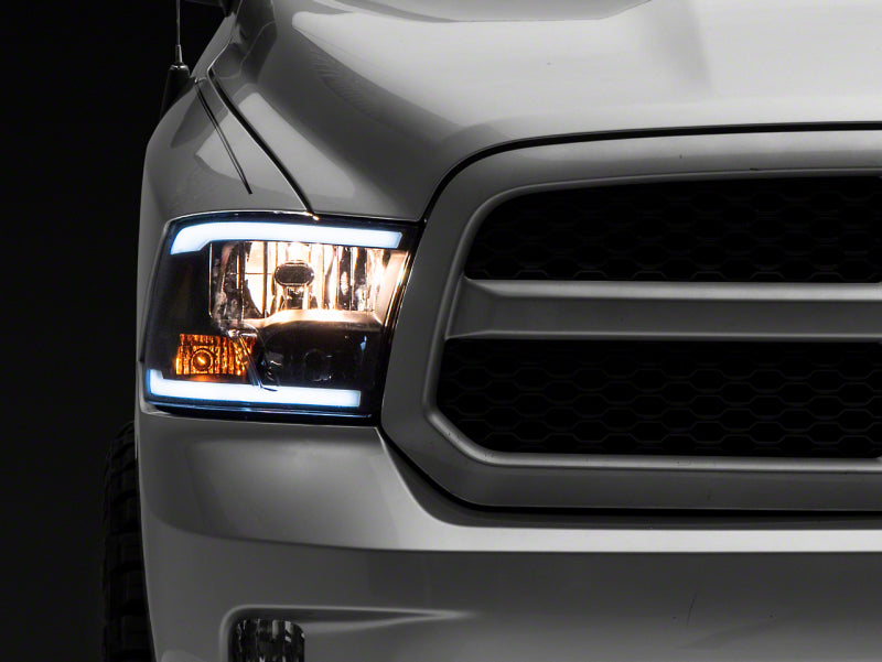 Raxiom 09-18 Dodge RAM 1500/2500/3500 Axial Series Headlights w/ LED Bar- Black Housing (Clear Lens)