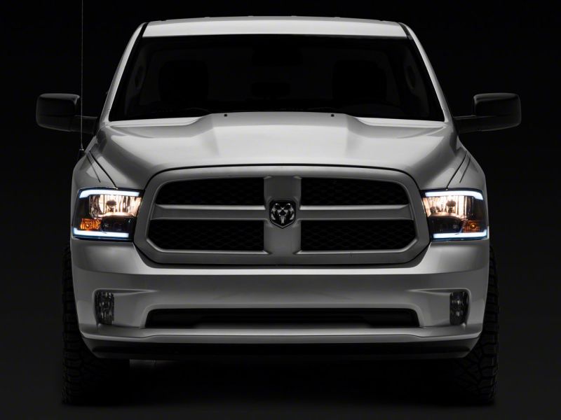Raxiom 09-18 Dodge RAM 1500/2500/3500 Axial Series Headlights w/ LED Bar- Black Housing (Clear Lens)