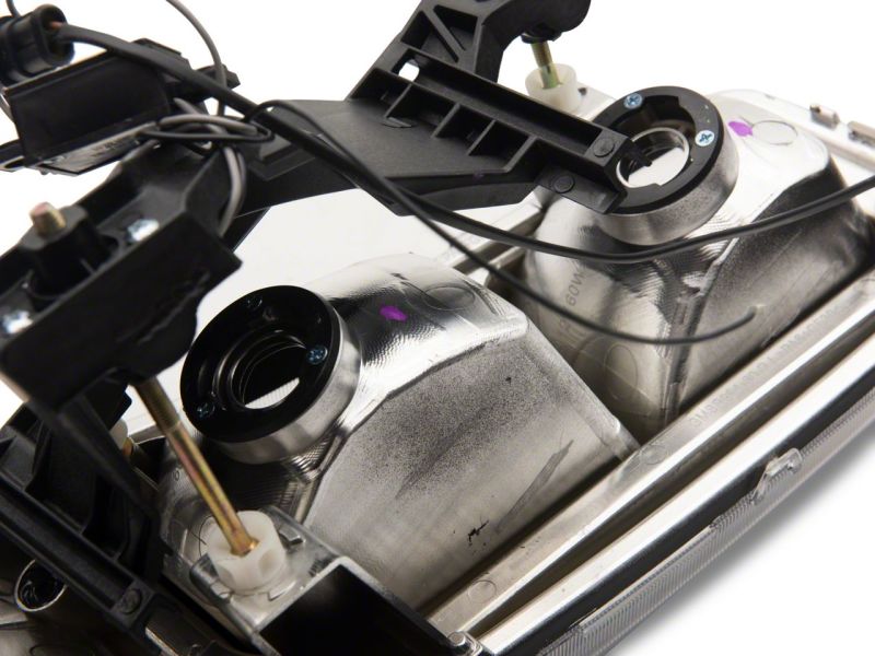 Raxiom 99-06 GMC Sierra 1500 Axial Series Headlights w/ LED Bar- Black Housing (Clear Lens)