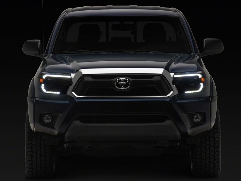 Raxiom 12-15 Toyota Tacoma Axial Series Switchback Projector Headlights- Black Housing- Clear Lens