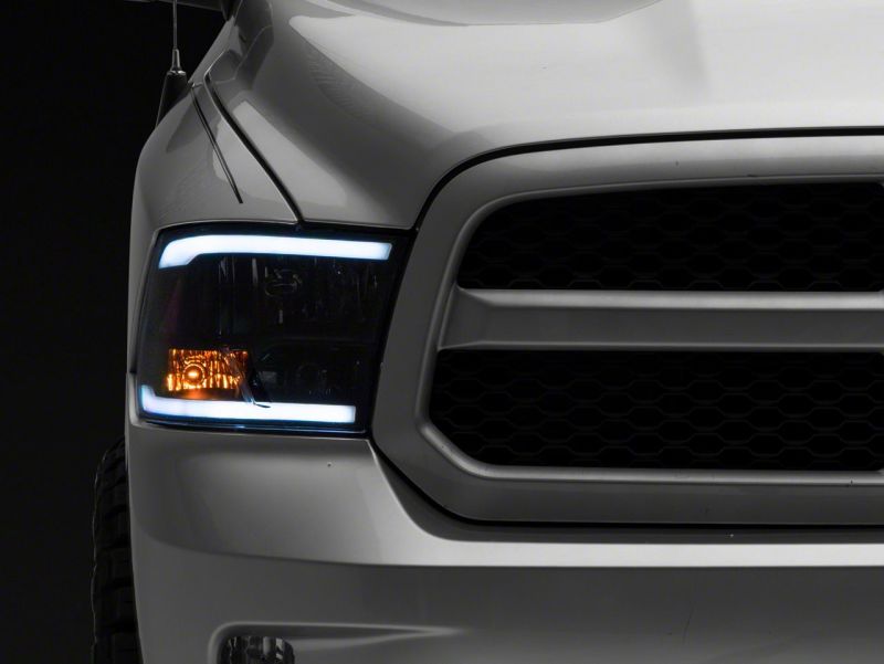 Raxiom 09-18 Dodge RAM 1500/2500/3500 Axial Headlights w/ SEQL LED Bar- Black Housing (Clear Lens)