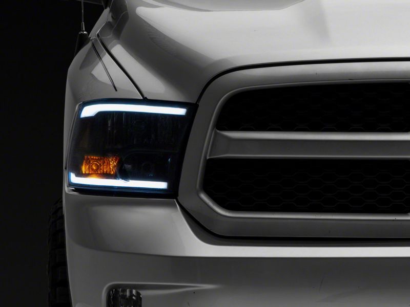 Raxiom 09-18 Dodge RAM 1500/2500/3500 Axial Series Headlights w/ LED Bar- Black Housing (Clear Lens)