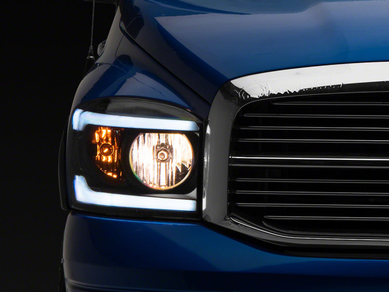 Raxiom 06-09 Dodge RAM 1500/2500/3500 Axial Headlights w/ SEQL LED Bar- Black Housing (Clear Lens)