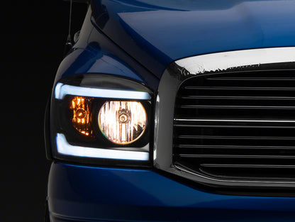 Raxiom 06-09 Dodge RAM 1500/2500/3500 Axial Headlights w/ SEQL LED Bar- Black Housing (Clear Lens)
