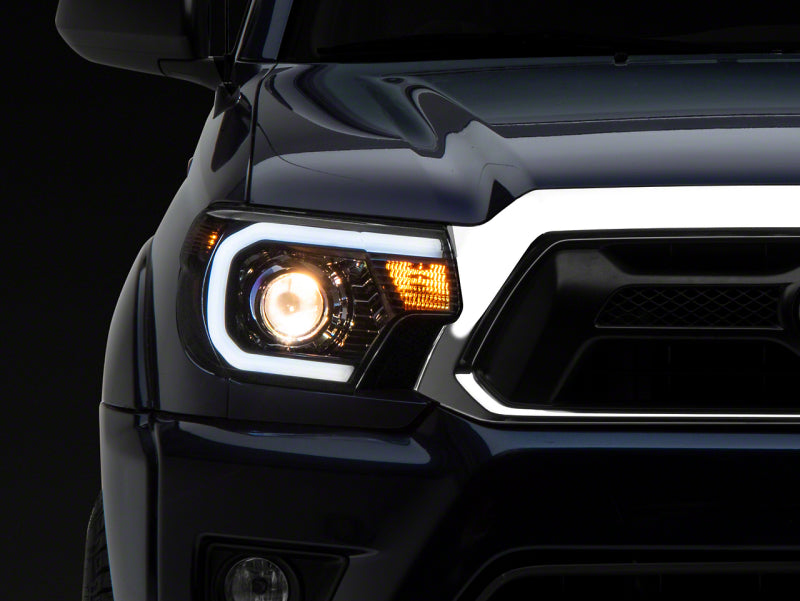 Raxiom 12-15 Toyota Tacoma Axial Series Projector Headlights w/ LED Bar- Black Housing (Clear Lens)