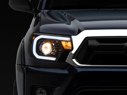 Raxiom 12-15 Toyota Tacoma Axial Series Projector Headlights w/ LED Bar- Black Housing (Clear Lens)